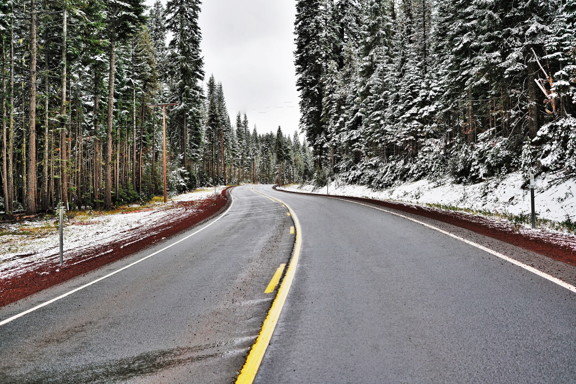 a photo of a snowy road near bend oregon photo by peter gonzalez